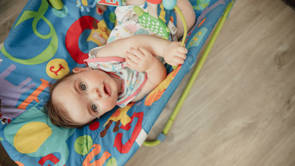 cute curious baby on the bouncer